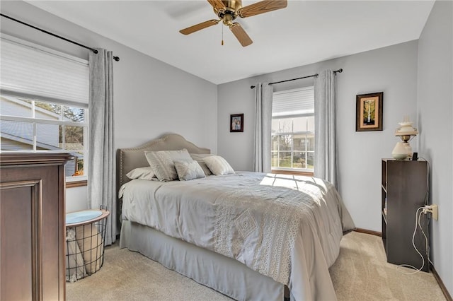 bedroom featuring ceiling fan and light colored carpet