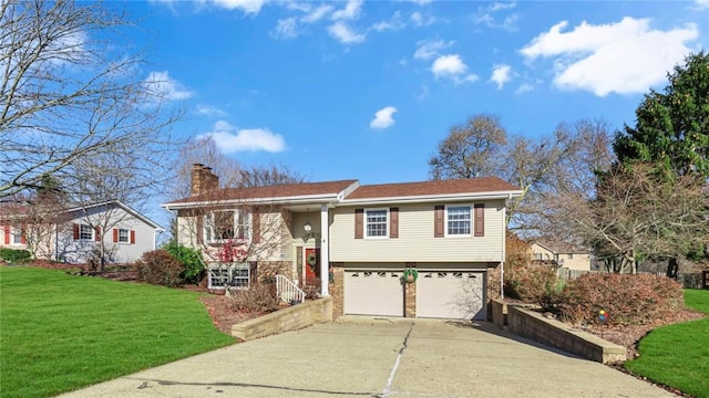 split foyer home with a front yard and a garage