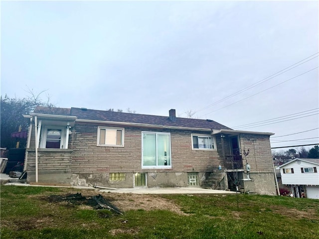 rear view of house with a lawn