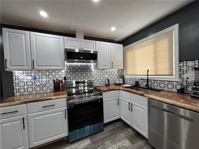 4430 Bowes Ave, West Mifflin, PA 15122 - kitchen with stainless steel appliances, a sink, decorative backsplash, white cabinets, and dark wood finished floors
