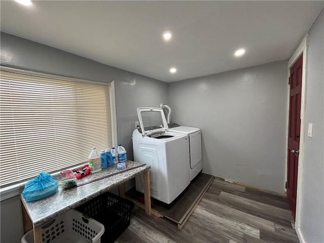 clothes washing area with dark hardwood / wood-style flooring and washing machine and dryer