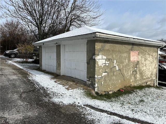 exterior space with a garage and an outdoor structure