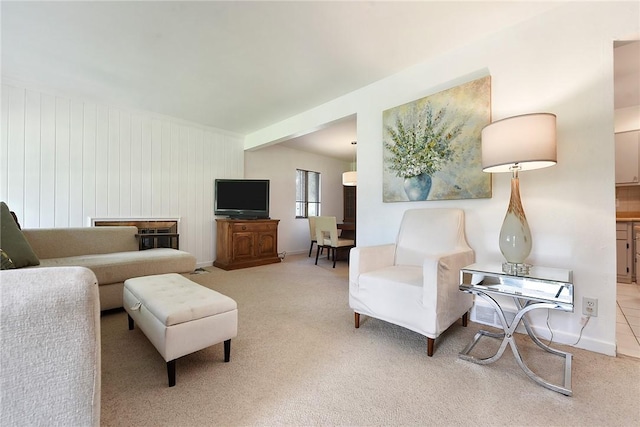 living room featuring light carpet and baseboards