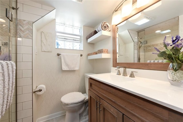 full bath with baseboards, toilet, vanity, and a shower stall