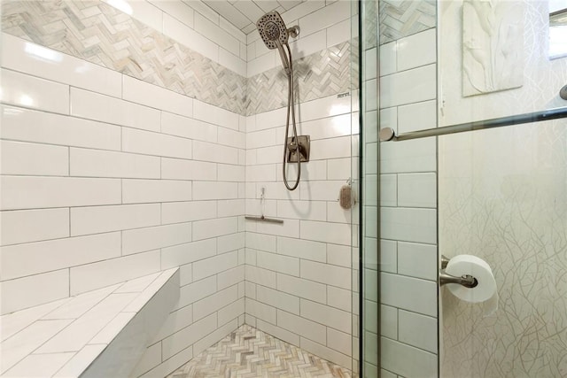 bathroom with tiled shower