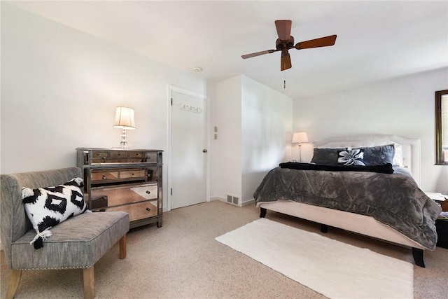 bedroom with light carpet, ceiling fan, and visible vents