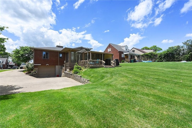 exterior space with a garage, concrete driveway, brick siding, and a lawn