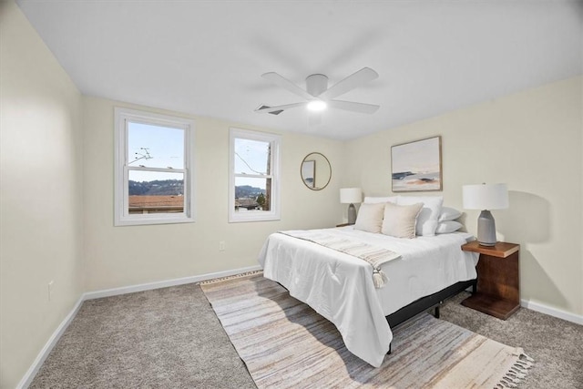 bedroom with ceiling fan and light carpet