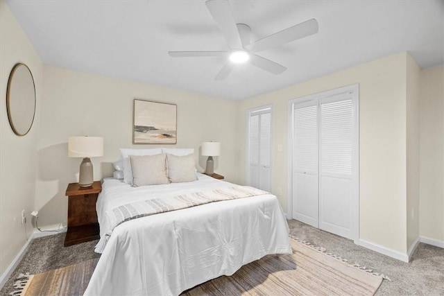 bedroom featuring carpet flooring, ceiling fan, and multiple closets