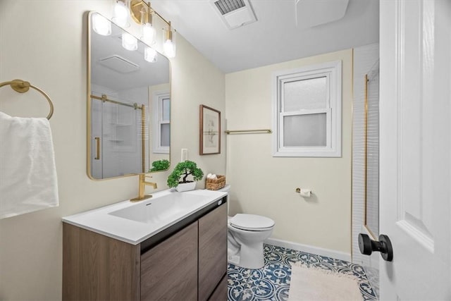 bathroom with tile patterned flooring, vanity, an enclosed shower, and toilet