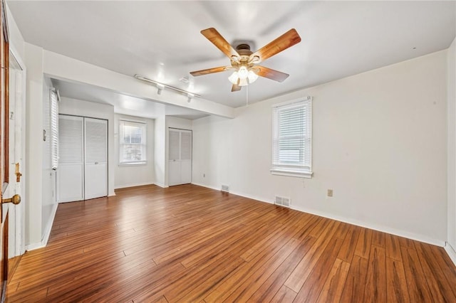 unfurnished bedroom featuring hardwood / wood-style floors and ceiling fan