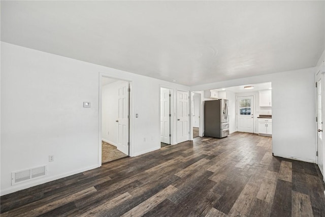 unfurnished living room featuring dark hardwood / wood-style flooring