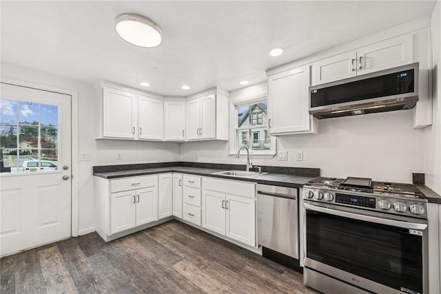 kitchen featuring white cabinets, appliances with stainless steel finishes, and sink