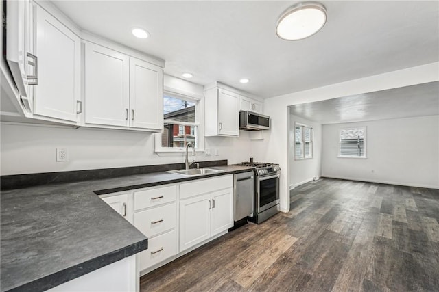 kitchen featuring dark hardwood / wood-style flooring, stainless steel appliances, white cabinetry, and sink