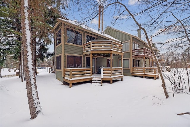 snow covered property featuring a wooden deck