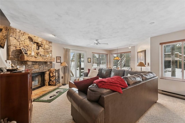 carpeted living room featuring a textured ceiling, ceiling fan, and a fireplace