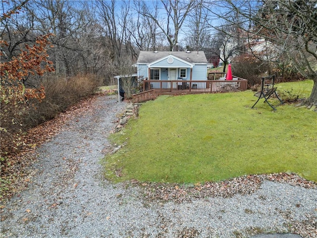 view of front of property featuring a front yard and a deck