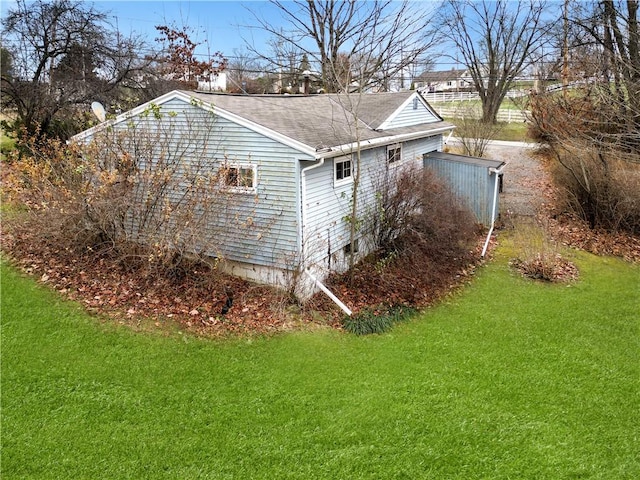 view of side of property with a lawn