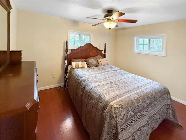 bedroom with ceiling fan and dark hardwood / wood-style floors