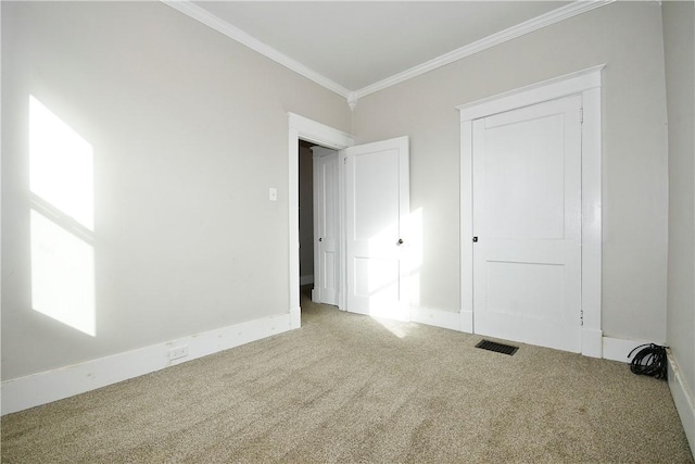 unfurnished bedroom with carpet floors, a closet, and crown molding