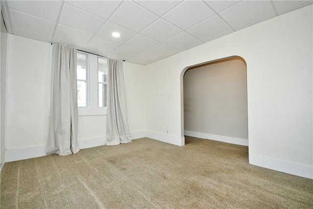 unfurnished room with a paneled ceiling and carpet