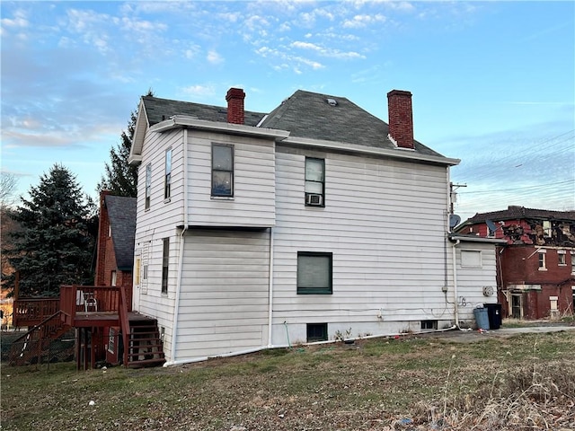 back of house with a yard and a deck