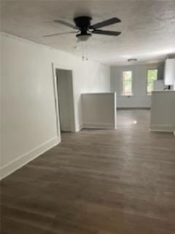 unfurnished room featuring ceiling fan and dark hardwood / wood-style flooring