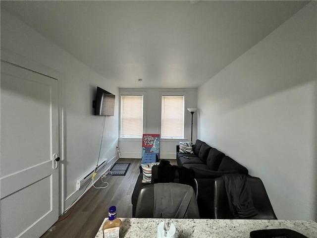 living room featuring baseboard heating and dark wood-type flooring