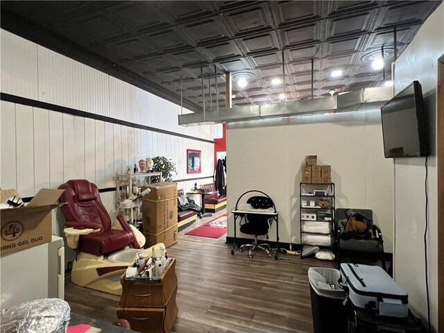 interior space with an ornate ceiling and wood finished floors
