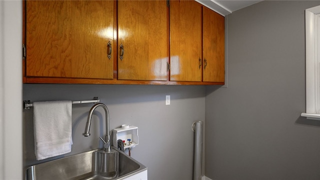 clothes washing area with washer hookup, cabinets, and sink