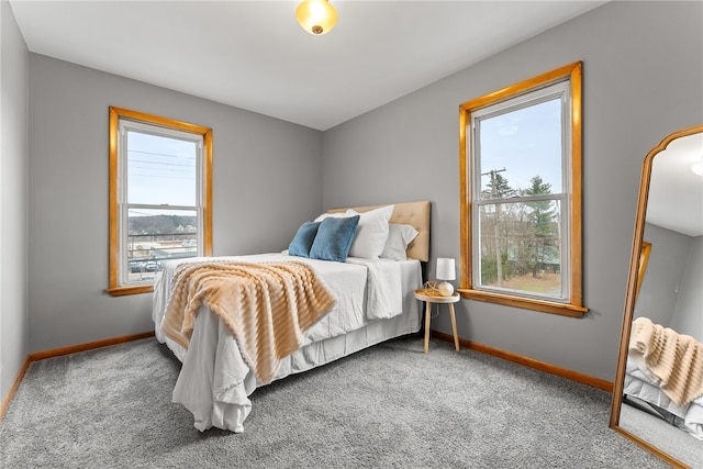 carpeted bedroom featuring multiple windows