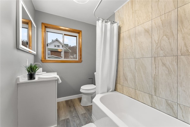 full bathroom featuring toilet, hardwood / wood-style floors, vanity, and shower / tub combo with curtain