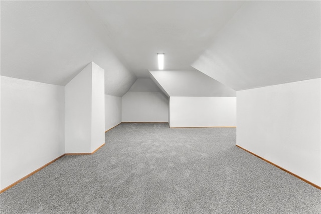 bonus room featuring carpet floors and vaulted ceiling