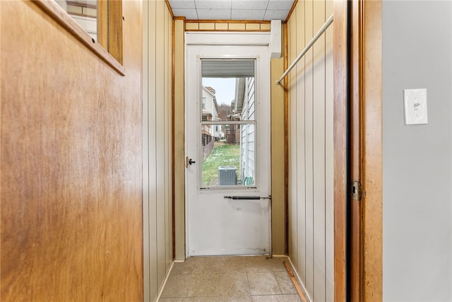 entryway featuring wood walls