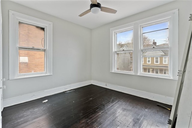 empty room with hardwood / wood-style floors and ceiling fan