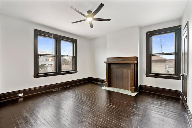 unfurnished room with dark hardwood / wood-style floors, ceiling fan, and a wealth of natural light