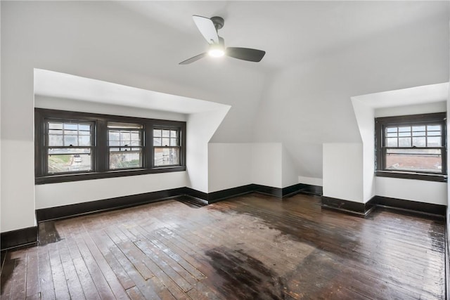 bonus room with plenty of natural light, dark hardwood / wood-style floors, and vaulted ceiling