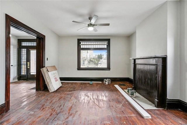 spare room with ceiling fan, hardwood / wood-style floors, and a healthy amount of sunlight