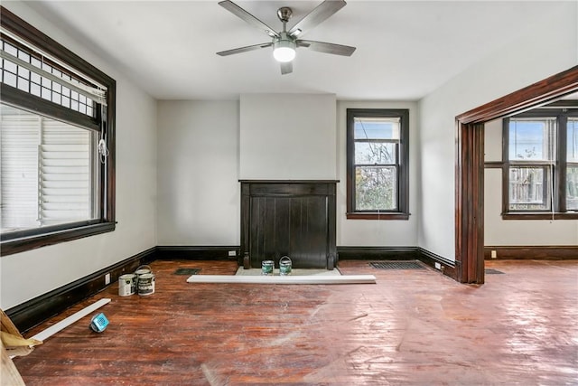 unfurnished living room with ceiling fan