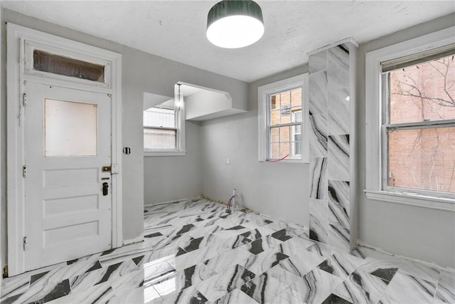 interior space with a textured ceiling and a wealth of natural light