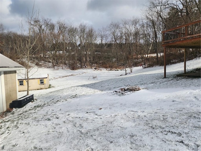 snowy yard featuring a deck