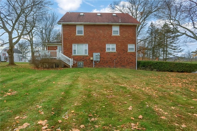 rear view of house with a yard