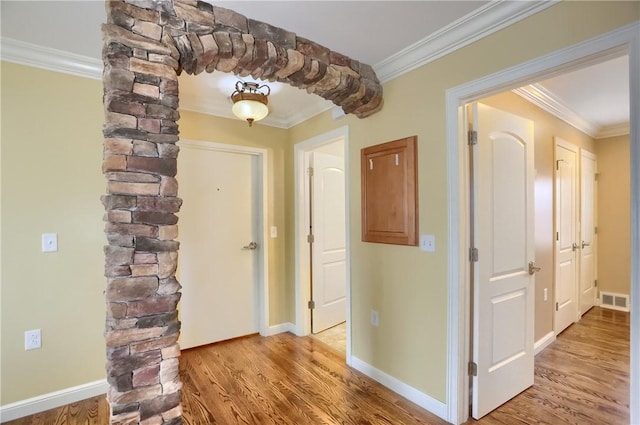 corridor featuring light hardwood / wood-style floors and crown molding