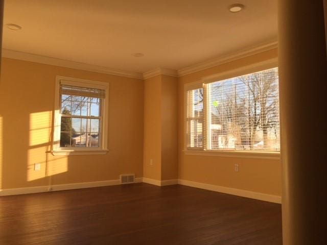 unfurnished room with dark hardwood / wood-style floors and crown molding