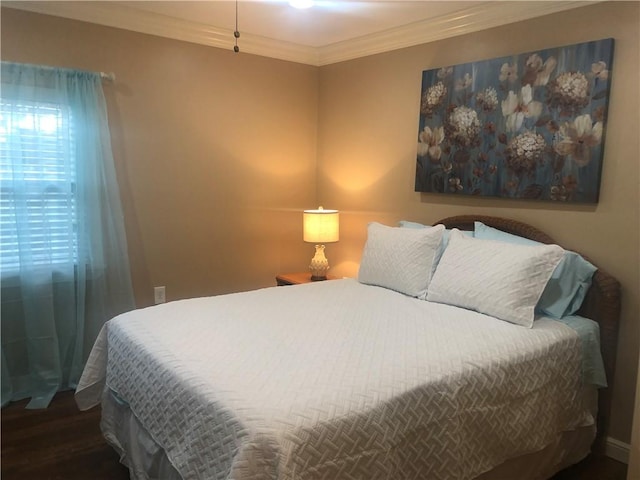 bedroom featuring dark hardwood / wood-style flooring and crown molding