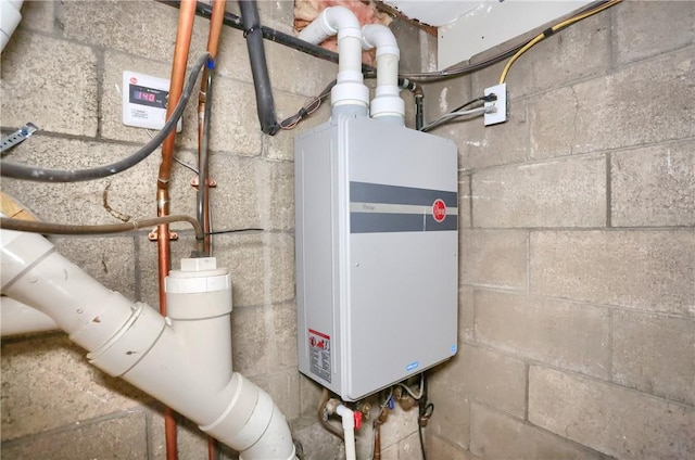 utility room featuring tankless water heater