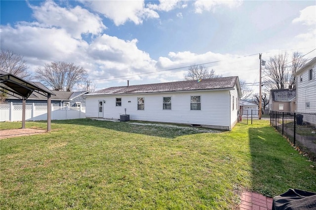 rear view of property featuring a yard