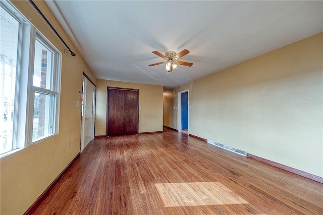 unfurnished bedroom featuring ceiling fan and hardwood / wood-style flooring