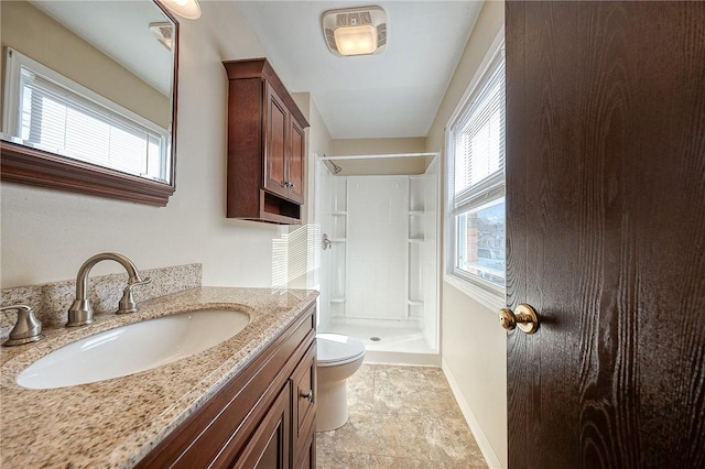 bathroom with vanity, toilet, and walk in shower