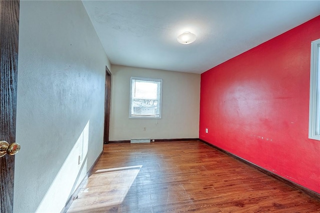 unfurnished room with hardwood / wood-style floors